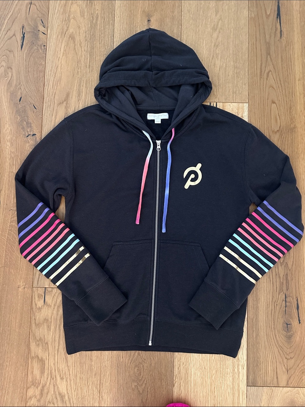 Women’s Spiritual Gangster x Peloton Black Zip-Up Hoodie with Rainbow Stripes.